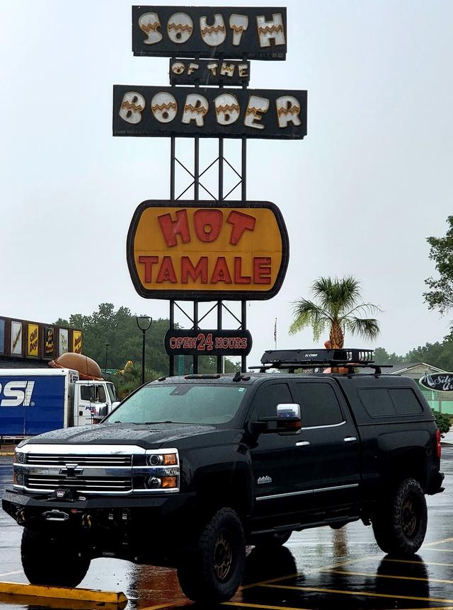 The truck parked under the South of the Border sign on a rainy afternoon